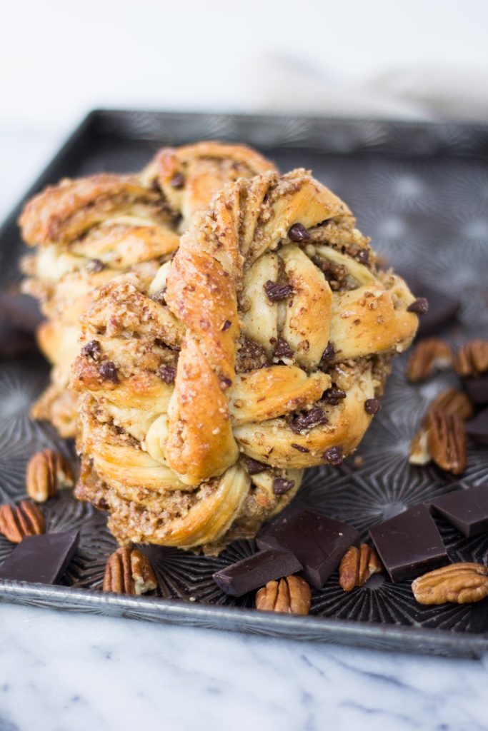 Chocolate Pecan Maple Knots - Softy, buttery dough is filled with the most delicious chocolate pecan pie filling and brushed with maple syrup. They are perfect for brunch, coffee or dessert, and one of my all time favorite pastry recipes! | www.thecraftingfoodie.com
